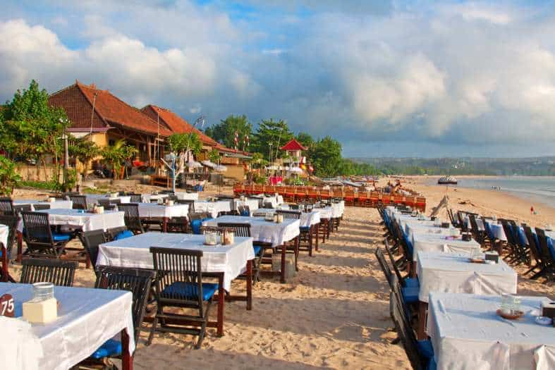 Tables lined up along the beach in Jimbaran Bali