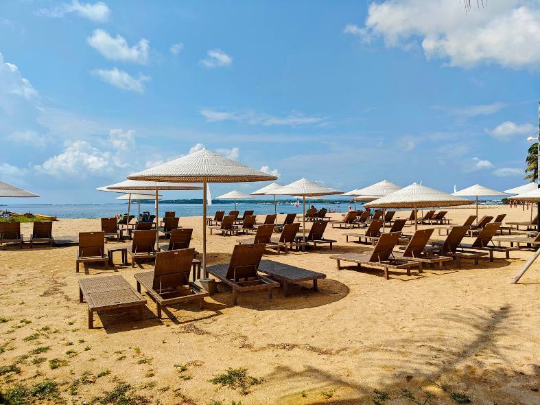 view of Sanur Beach in Indonesia, featuring clear blue waters under a sunny sky