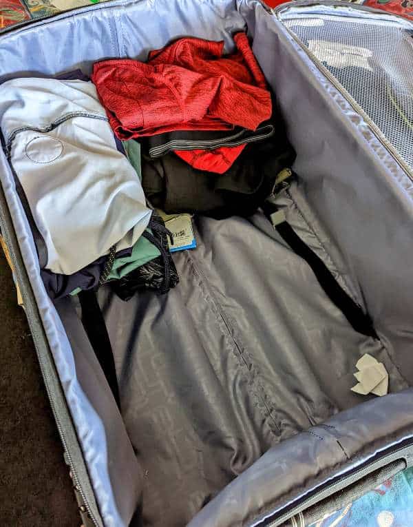 a suitcase with some clothes in it, packing for a bali holiday