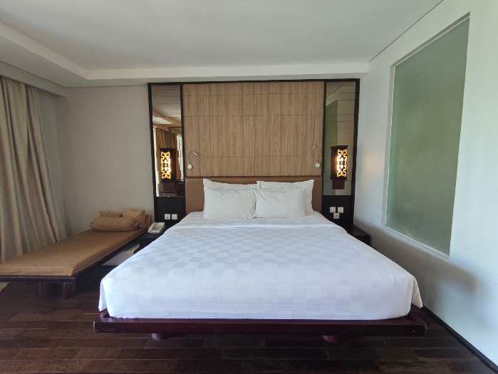 a bedroom with big bed and day bed at Sanur Resort Watujimbar
