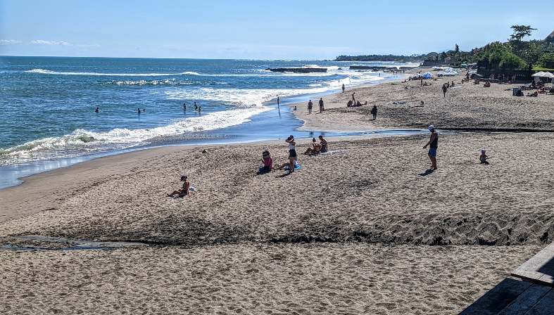 people enjoy the beach at Canggu in Bali. For many visitors to Bali they are unsure whether to stay in Sanur or Canggu