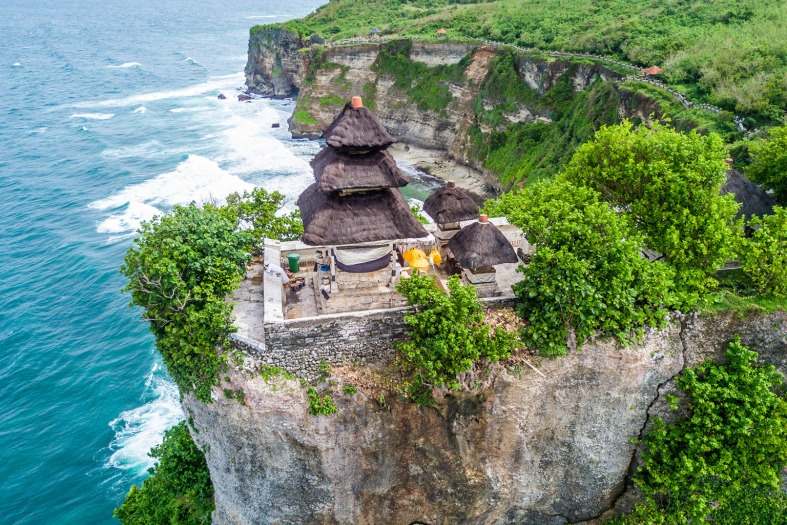 The Uluwatu Temple is located on a stunning cliff neat the ocean